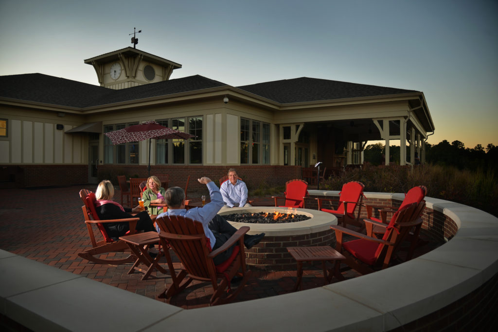 A group relaxes around the outdoor fire pit at the Terrace Dining Room.