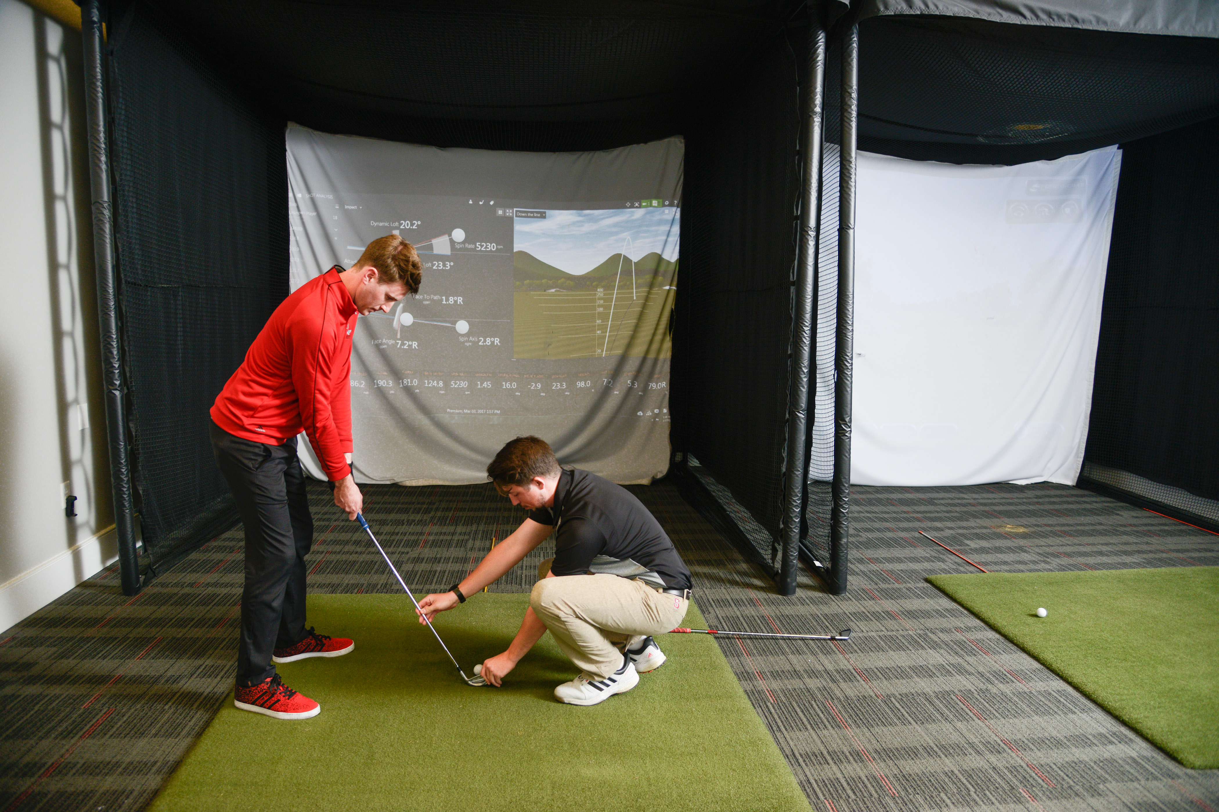 A golfer receives instruction from player development staff.